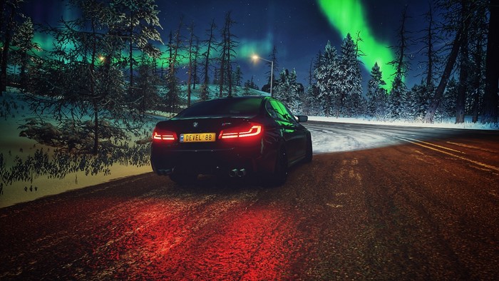 BMW M5 F90 on a snowy road with aurora borealis