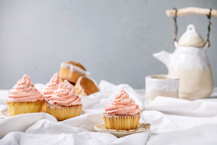 Cupcakes with pink frosting and a teapot