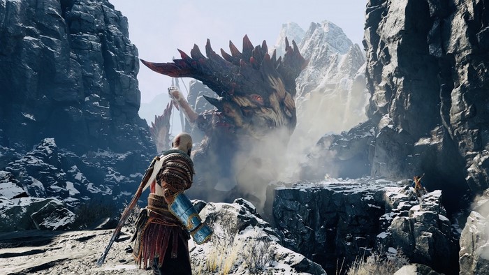 Kratos from God of War facing a dragon