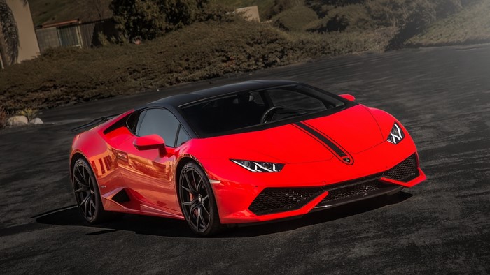Red Lamborghini Huracan with black stripes on road