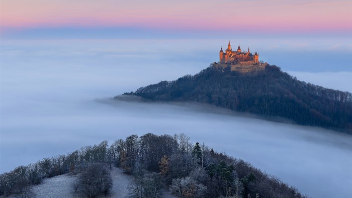 Hohenzollern Castle above the clouds at sunrise
