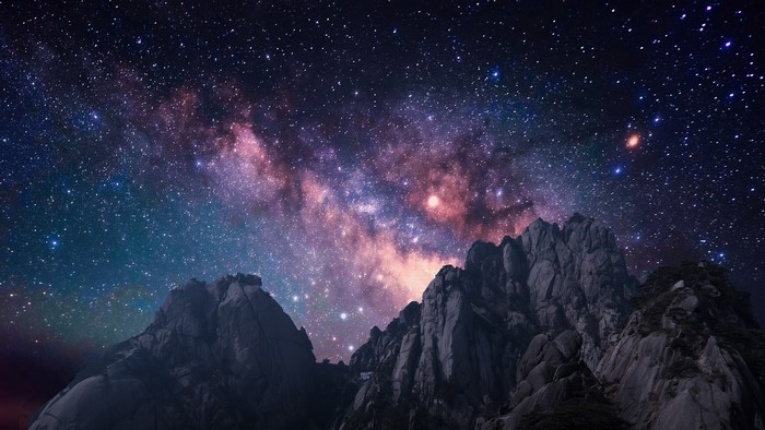 Milky Way over rocky mountains at night