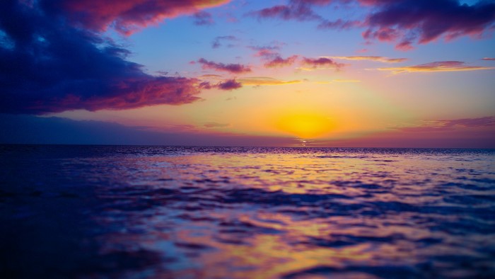 Sunset over the ocean with colorful clouds