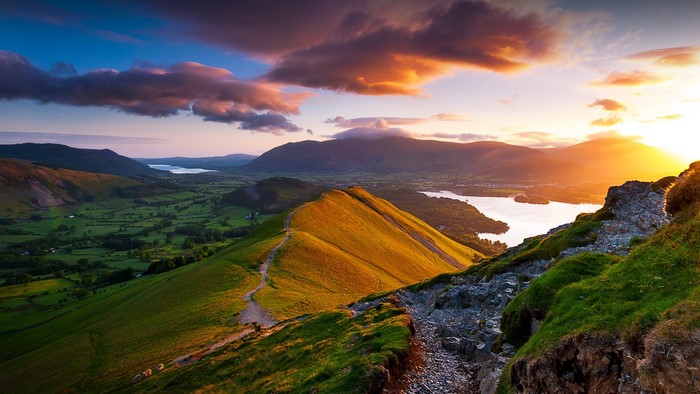 Sunrise over a lake and mountains in the Lake District, UK