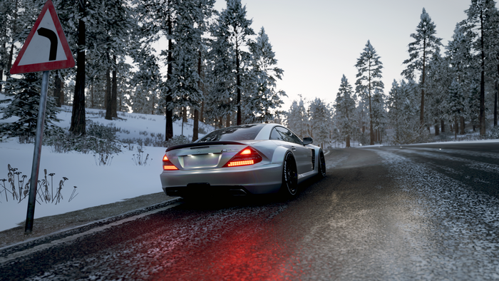Silver Mercedes-Benz SL in a snowy forest road