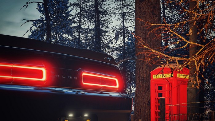 Dodge Demon car next to a red phone box in a forest