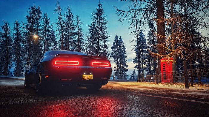 Dodge SRT Demon in a snowy forest with a red phone booth