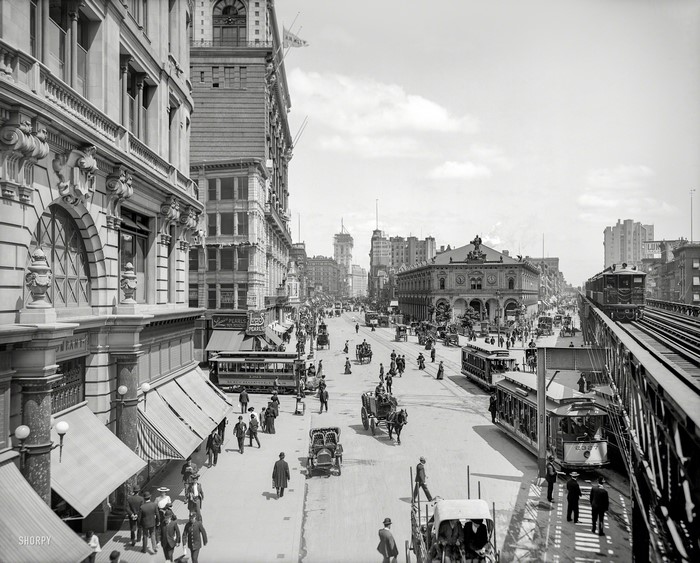 Street scene with horse-drawn carriages and trolleys in New York City