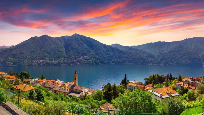 Lake Como village with mountains and sunset sky