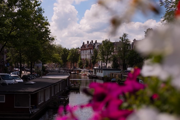 Amsterdam canal with houseboats and buildings