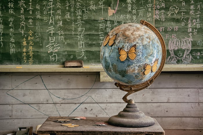 Globe with butterflies in a classroom