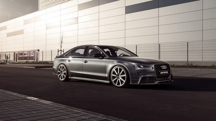 MTM tuned Audi S8 sedan parked in front of a modern building