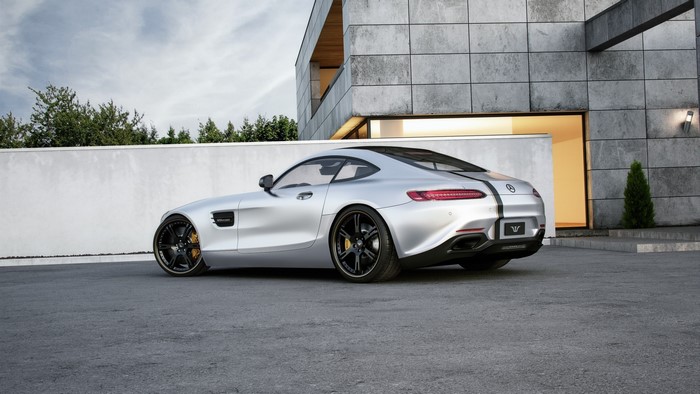 Silver Mercedes-AMG GT parked near a modern house