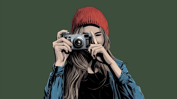 Woman in red beanie taking a photo with a vintage camera