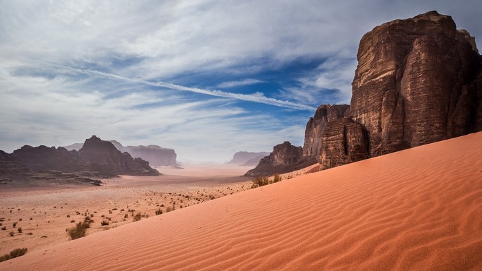 Desert landscape with sand dunes and rock formations in Wadi Rum, Jordan