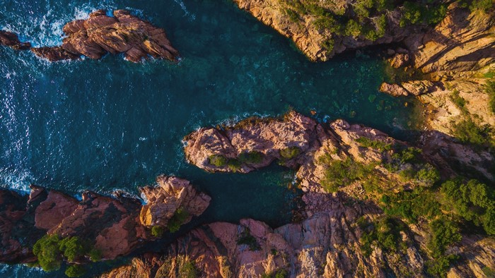 Aerial view of rocky coastline and turquoise sea in Catalonia, Spain