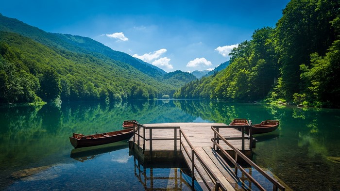 Wooden pier with boats on Biogradsko Lake, Montenegro