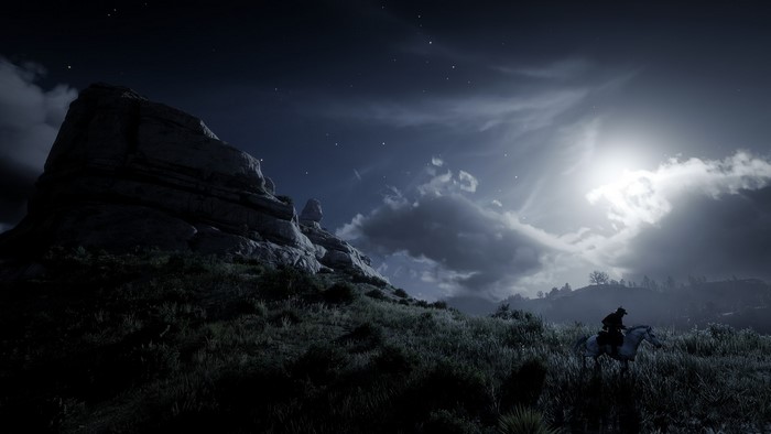 Red Dead Redemption 2 screenshot of a man on horseback at night