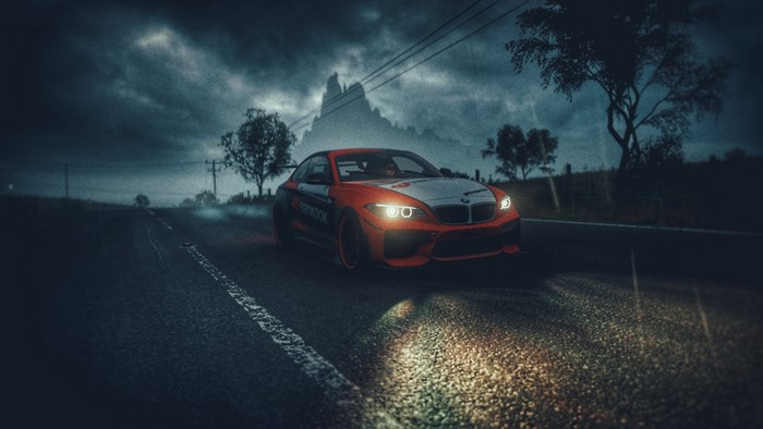 BMW M2 on a wet road at night