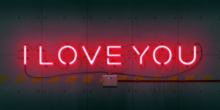 Red neon sign "I LOVE YOU" on a textured wall