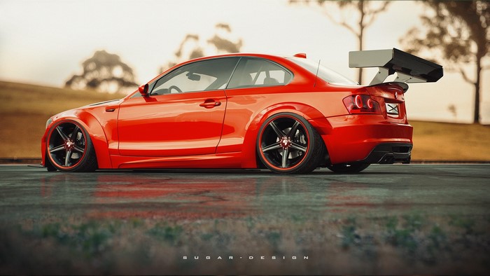Red BMW 1 Series Coupe with a large rear spoiler