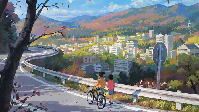 Couple with bicycle on a winding road overlooking a city in autumn