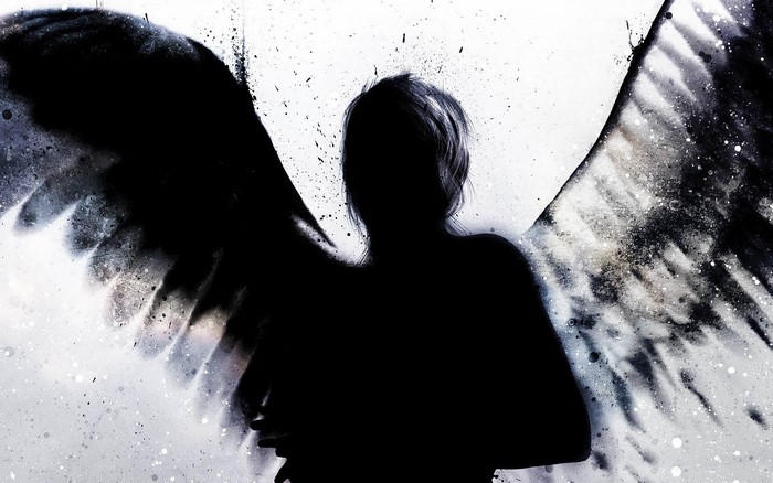 Silhouette of an angel with dark wings