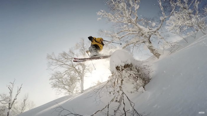 Skier jumping in snowy mountains of Japan