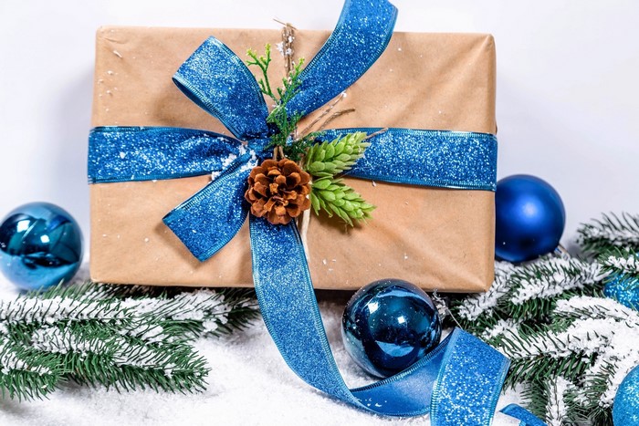Christmas gift with blue ribbon and ornaments