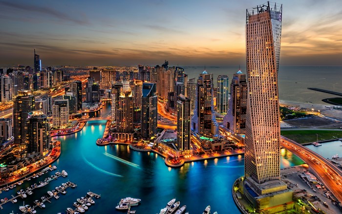 4K Dubai cityscape with marina and skyscrapers at dusk