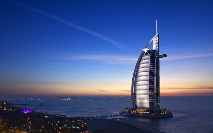 4K Burj Al Arab skyscraper over the sea at dusk