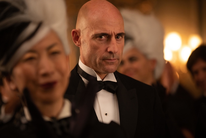 Mark Strong as Cruella in a tuxedo