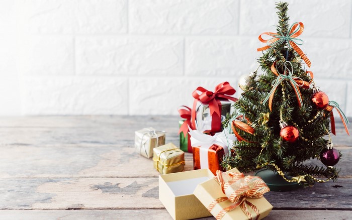 Christmas tree with presents on wooden table