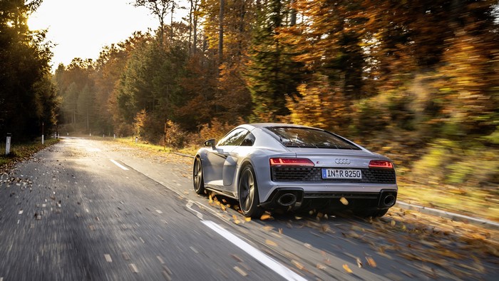 Audi R8 V10 driving on a forest road in autumn
