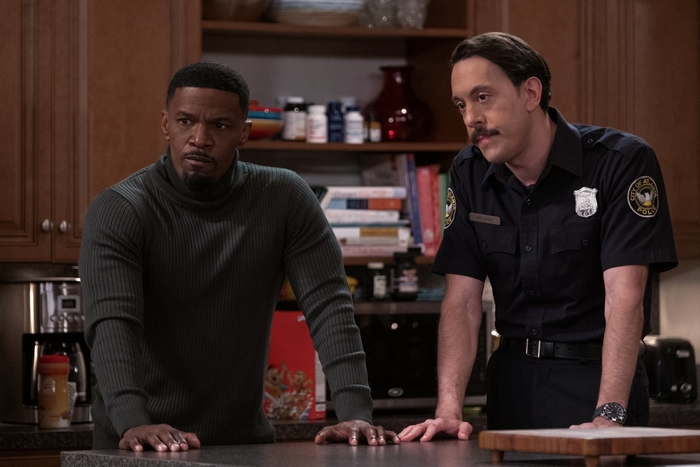 Jamie Foxx and a police officer in a kitchen