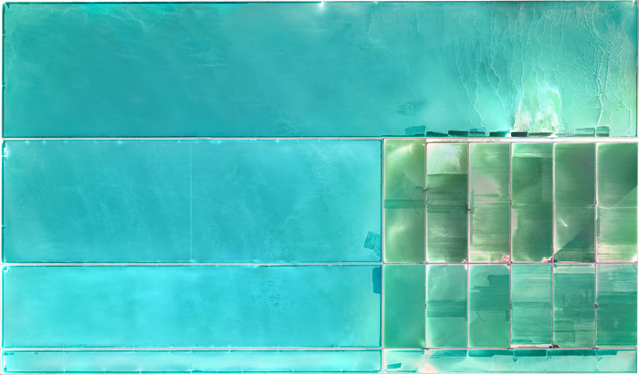 Aerial view of salt flats with cyan and green water