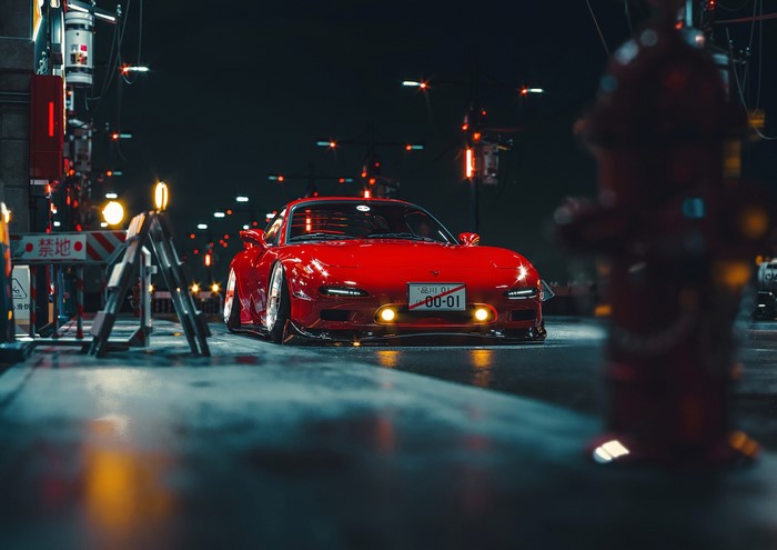 Red Mazda RX-7 FD with negative camber at night