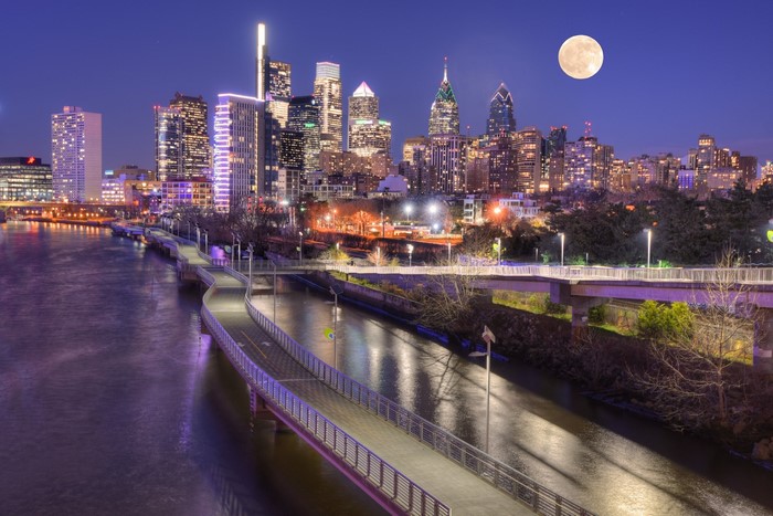 Philadelphia cityscape with full moon over the Delaware River