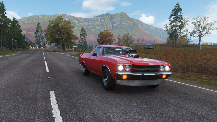 Red muscle car on a road in Forza Horizon 4