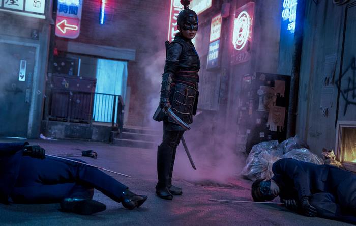 Katana in a neon-lit alley with defeated opponents