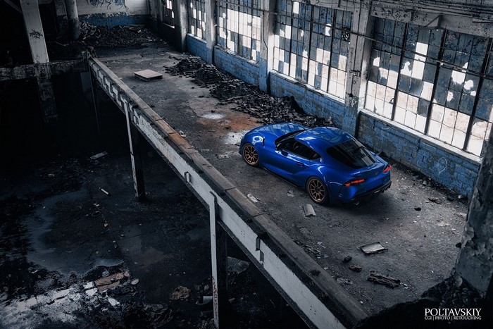 Blue Toyota Supra in abandoned industrial building