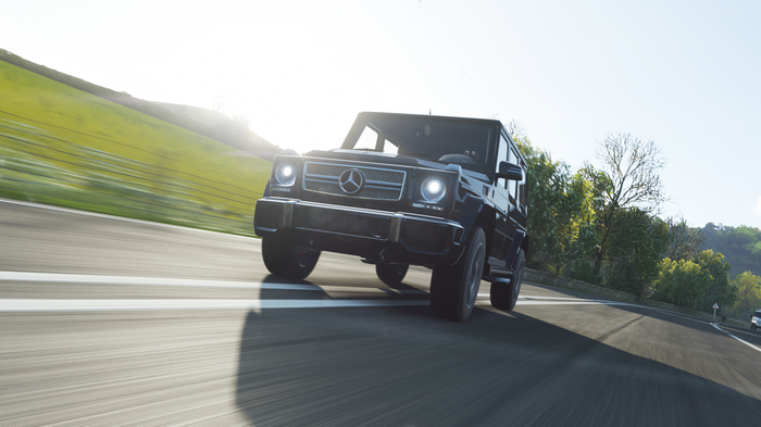 Mercedes-Benz G-Wagon driving on a sunny road