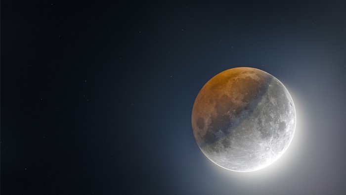 Moon during a lunar eclipse with stars