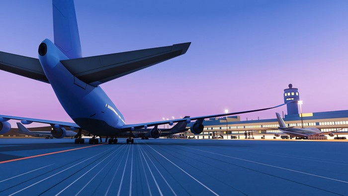 Passenger aircraft at airport terminal at dusk