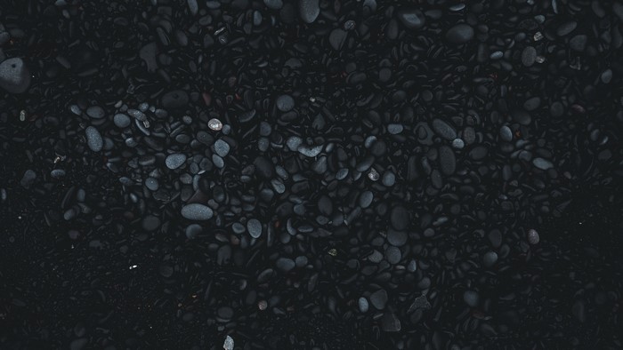 Dark stones and pebbles on a beach