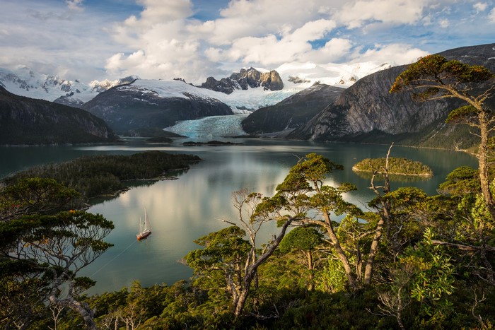 Sailboat on a lake with mountains and glacier