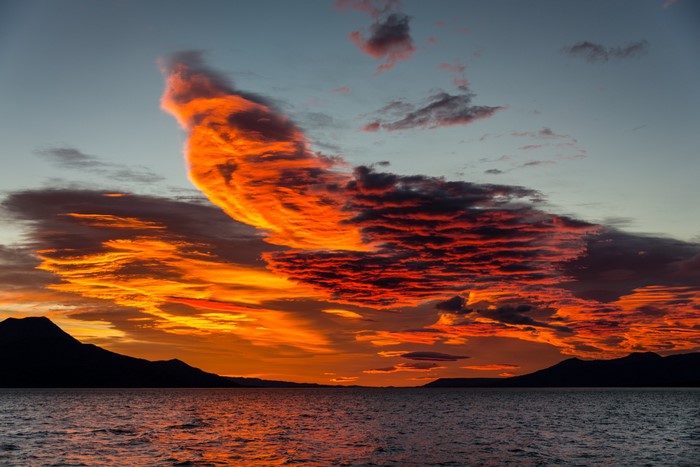Sunset over the ocean with dramatic clouds