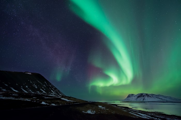 Aurora Borealis over snowy Icelandic landscape at night