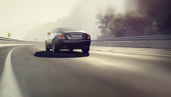 Rolls-Royce car driving on a winding road