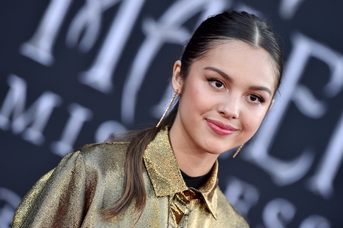 Olivia Rodrigo in a gold jacket
